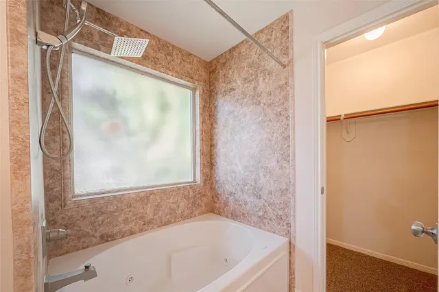 a bathroom with a bathtub and a shower