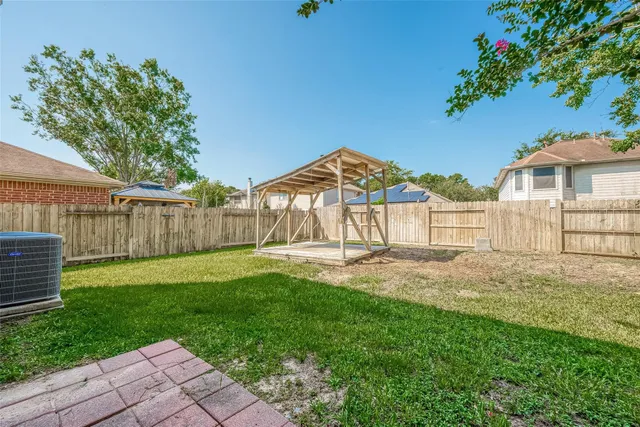 a view of a house with a yard and sitting area