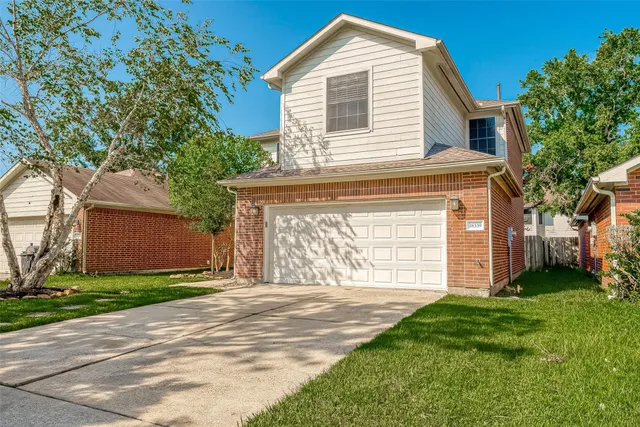 a front view of a house with a yard and garage