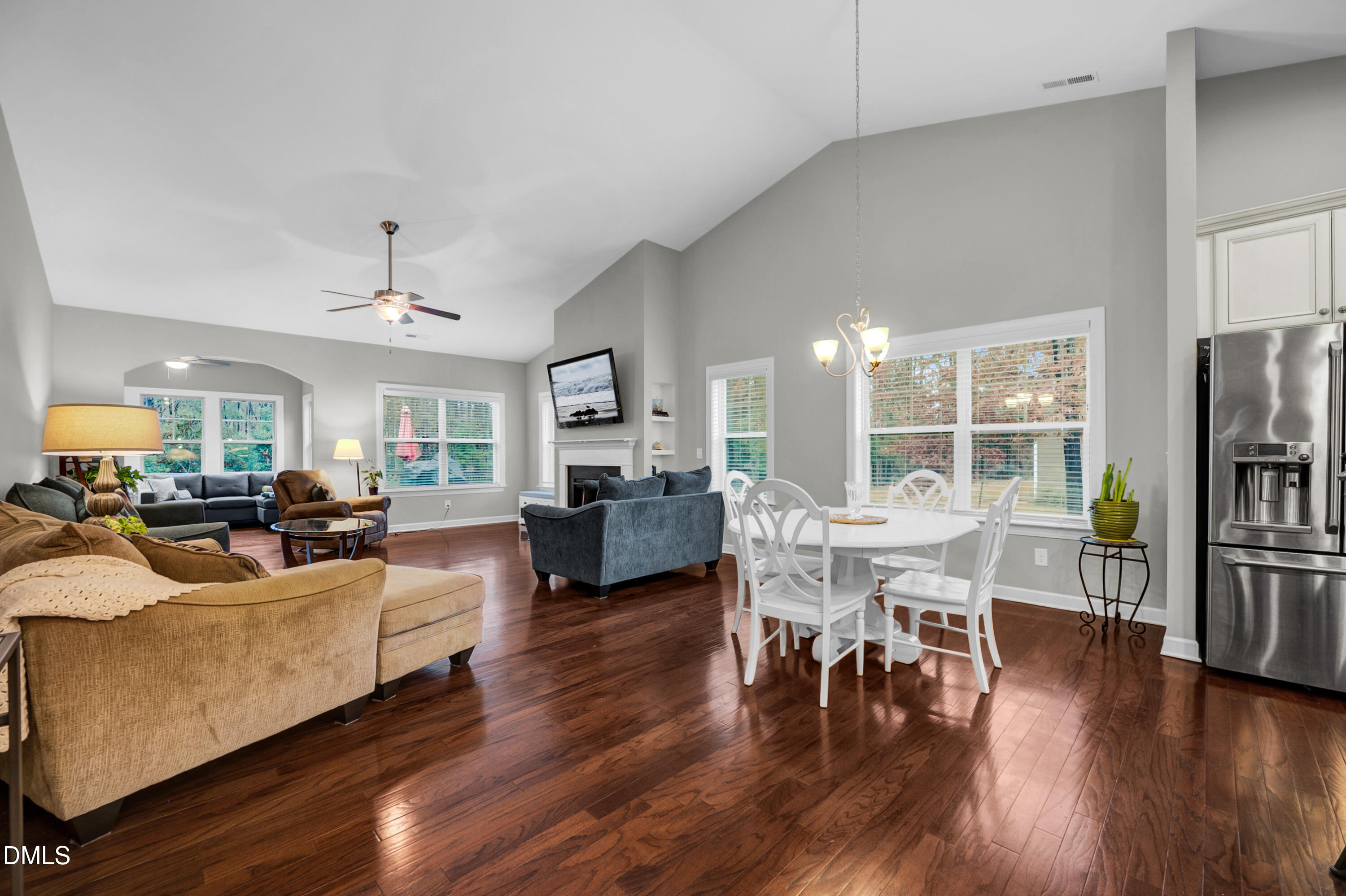 8621 Jordan Meadow Drive Fuquay-Varina, NC 27526 - Photo 12 of 55 a living room with furniture wooden floor and a flat screen tv