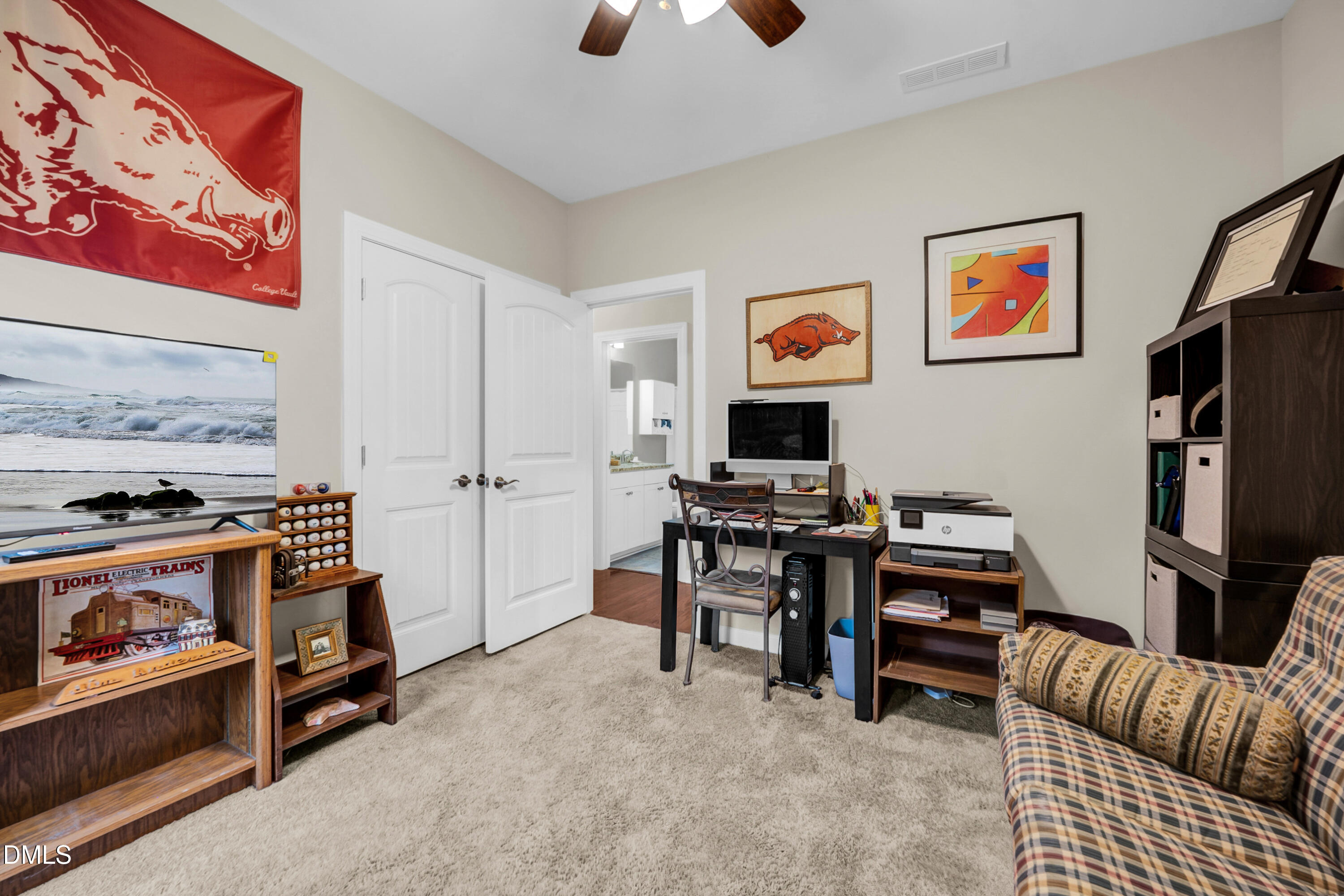 8621 Jordan Meadow Drive Fuquay-Varina, NC 27526 - Photo 19 of 55 a view of a workspace with furniture and a flat screen tv