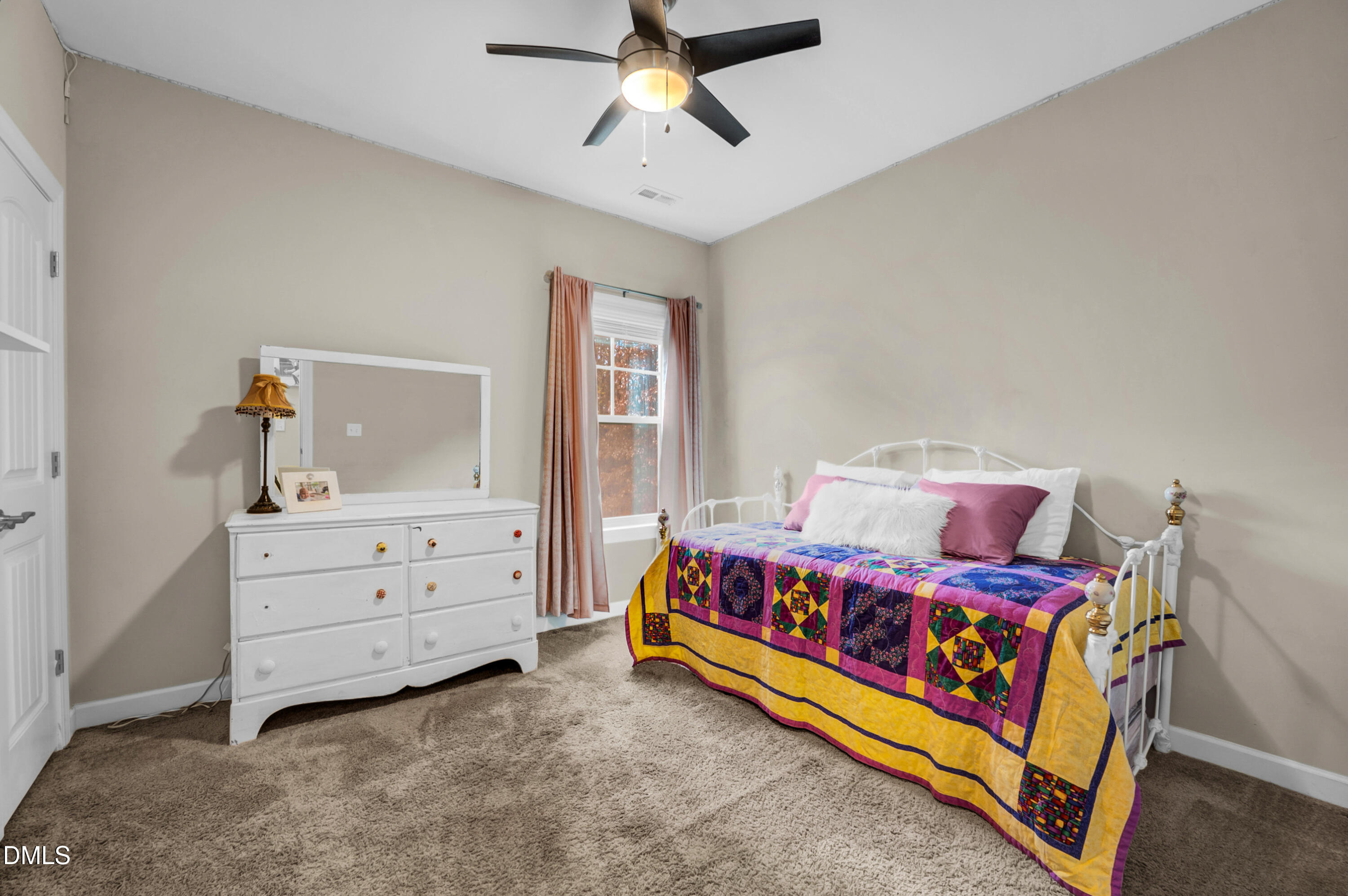 8621 Jordan Meadow Drive Fuquay-Varina, NC 27526 - Photo 20 of 55 a bedroom with a bed and a dresser in it