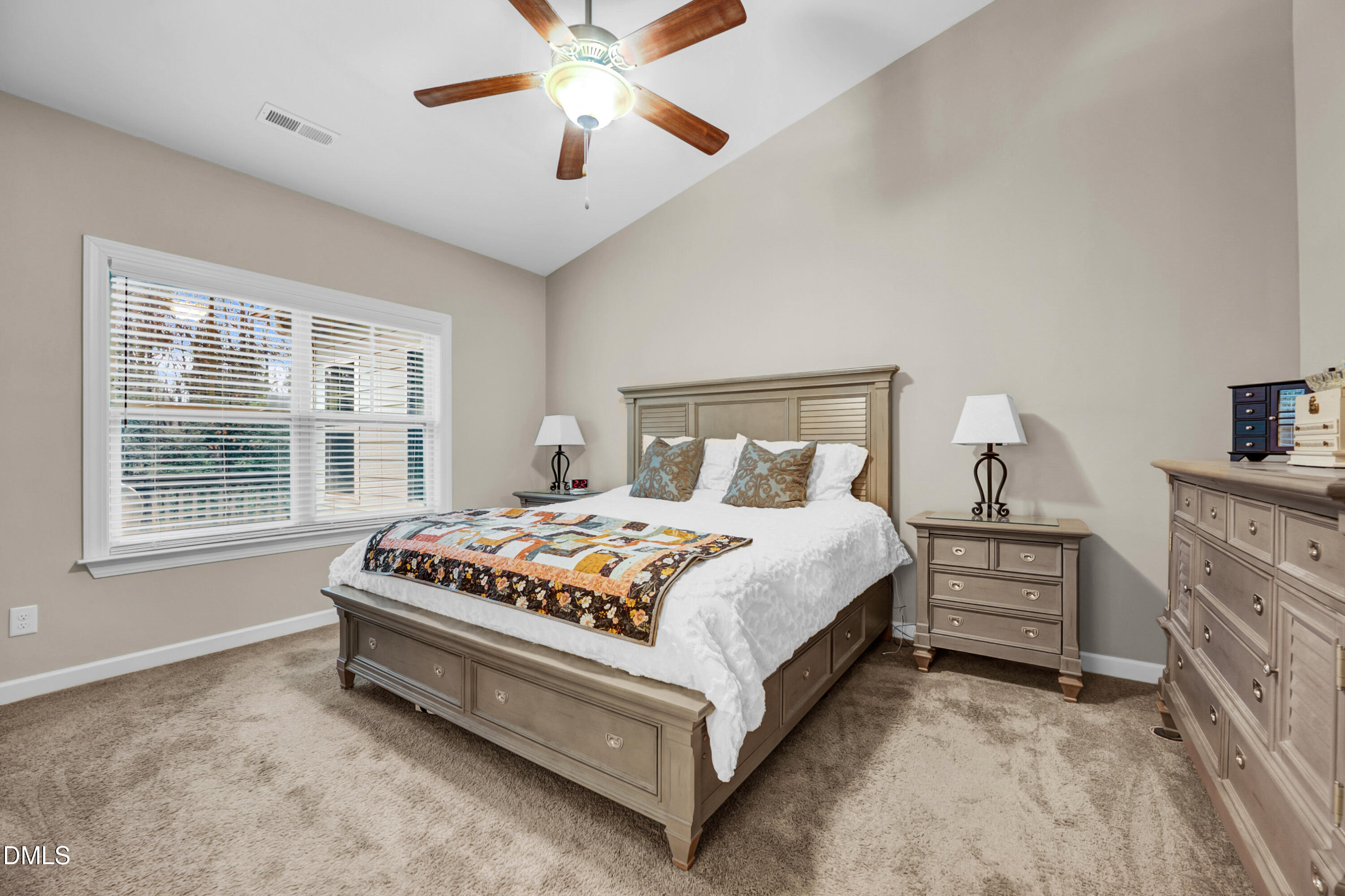 8621 Jordan Meadow Drive Fuquay-Varina, NC 27526 - Photo 23 of 55 a bedroom with a bed and a chandelier