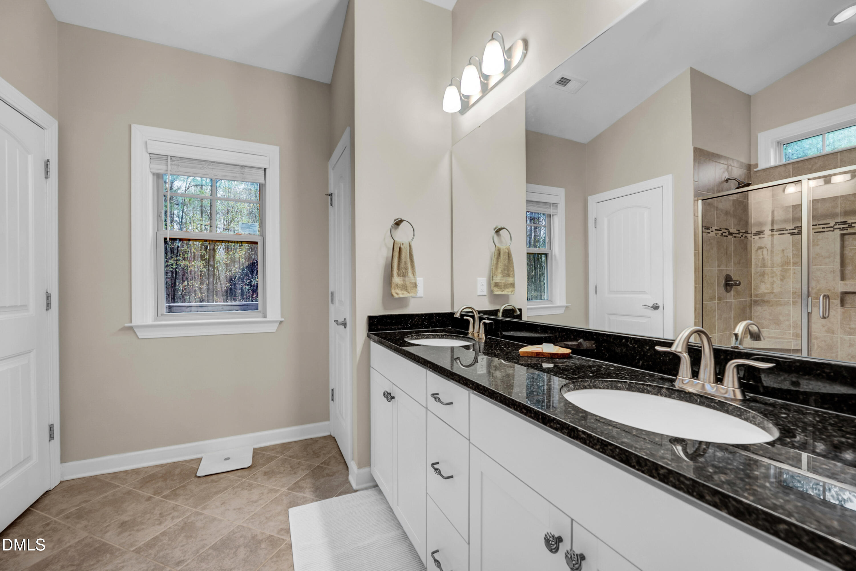 8621 Jordan Meadow Drive Fuquay-Varina, NC 27526 - Photo 26 of 55 a bathroom with a granite countertop double vanity sinks and a mirror