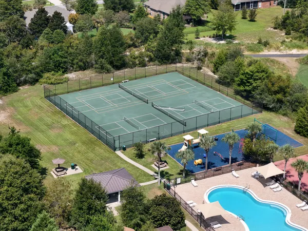 an aerial view of a house with a yard basket ball court and outdoor seating
