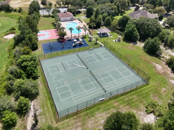 an aerial view of a house with a swimming pool outdoor seating