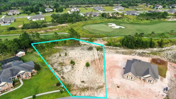 an aerial view of residential houses with outdoor space and swimming pool