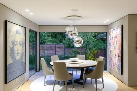 a view of a dining room furniture and chandelier