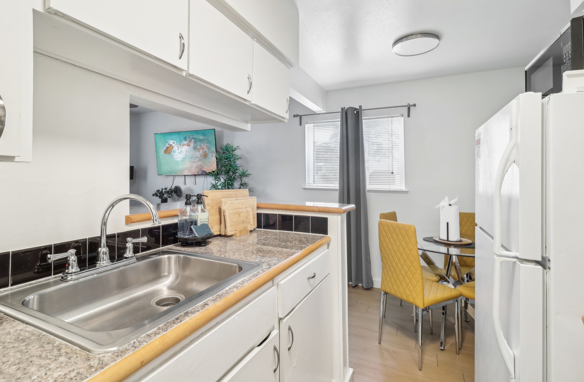 3107 Speedway, Unit 207 Austin, TX 78705 - Photo 5 of 12 a kitchen with a sink cabinets and wooden floor