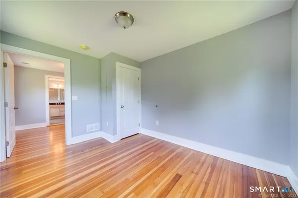 a spacious bathroom with a toilet a sink and shower