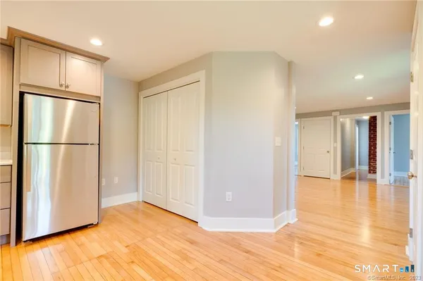 a view of empty room with wooden floor