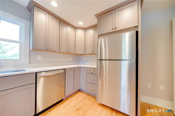 a kitchen with cabinets a refrigerator and a sink