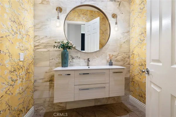 a bathroom with a sink mirror and vanity