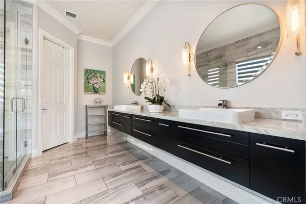 a bathroom with a double vanity sink and a mirror