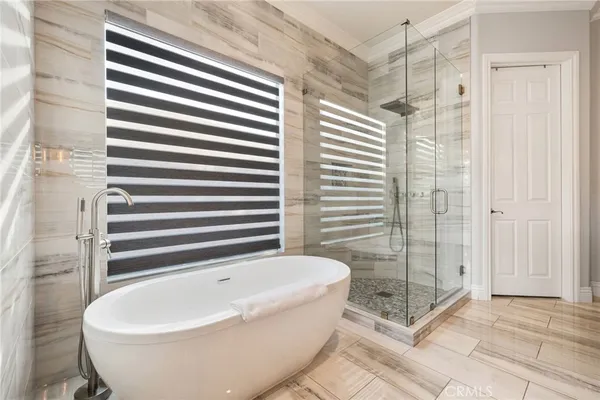 a bathroom with a bathtub and shower