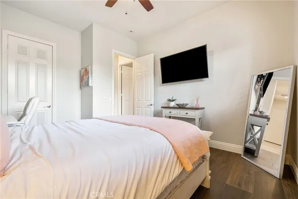 a bedroom with a flat screen tv and a bed