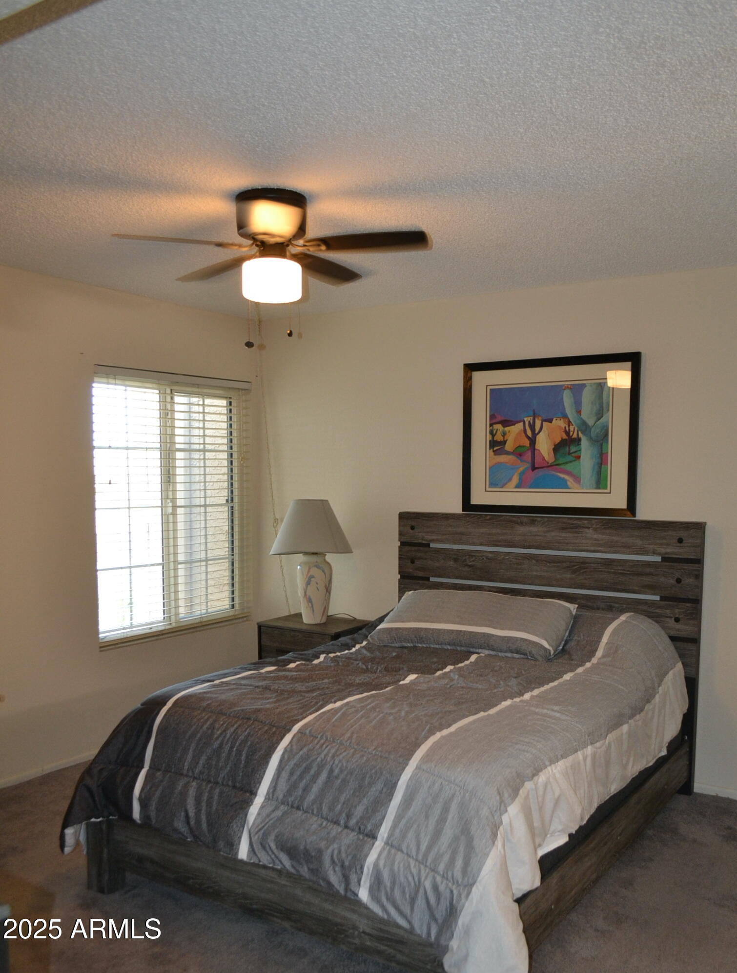 455 South Delaware Drive, Unit 112 Apache Junction, AZ 85120 - Photo 12 of 16 a bedroom with a bed and a chandelier