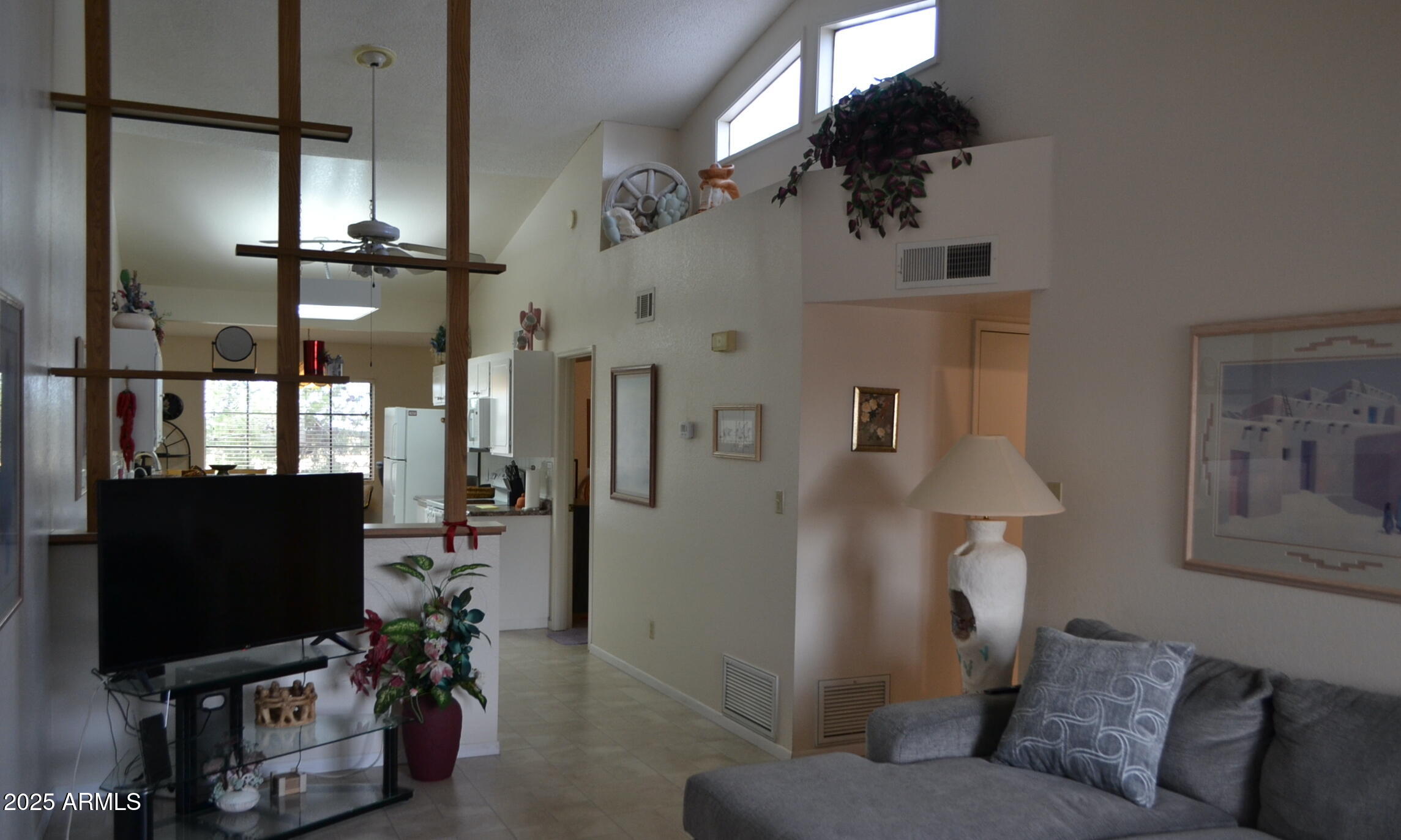 455 South Delaware Drive, Unit 112 Apache Junction, AZ 85120 - Photo 2 of 16 a living room with furniture and a flat screen tv