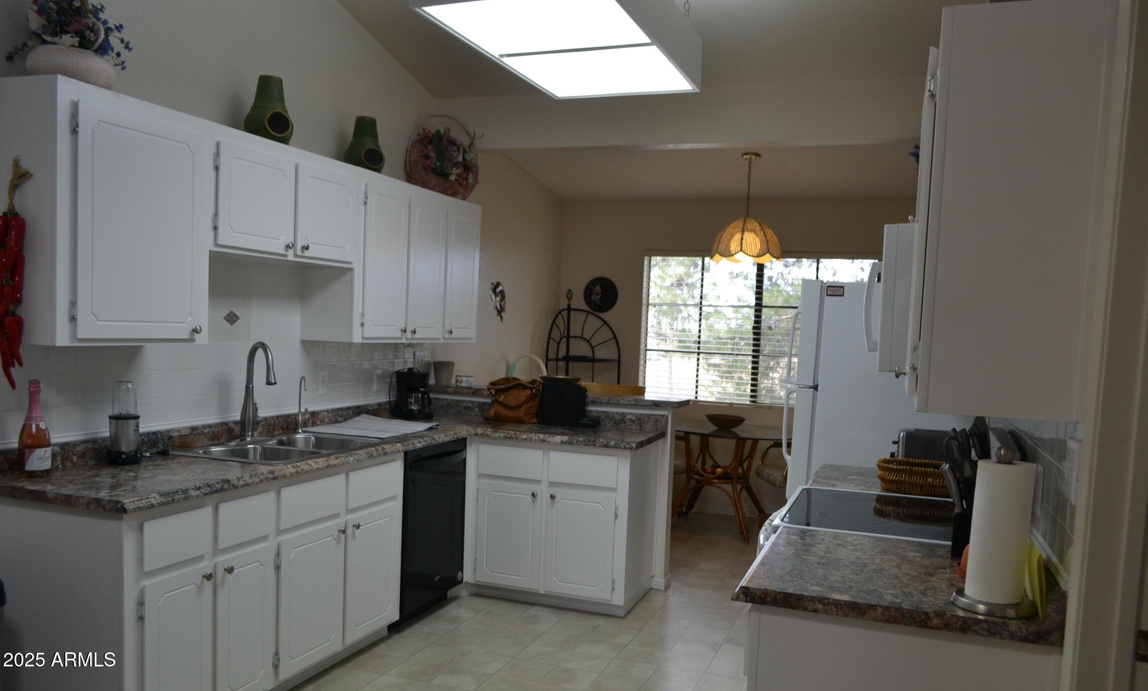 455 South Delaware Drive, Unit 112 Apache Junction, AZ 85120 - Photo 6 of 16 a kitchen with granite countertop a sink stove and cabinets