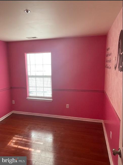 3516 Corn Stream Road Randallstown, MD 21133 - Photo 48 of 66 an empty room with wooden floor and windows