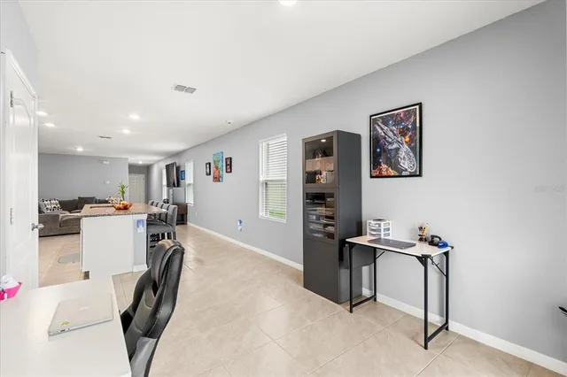 a view of a workspace with furniture and a workspace