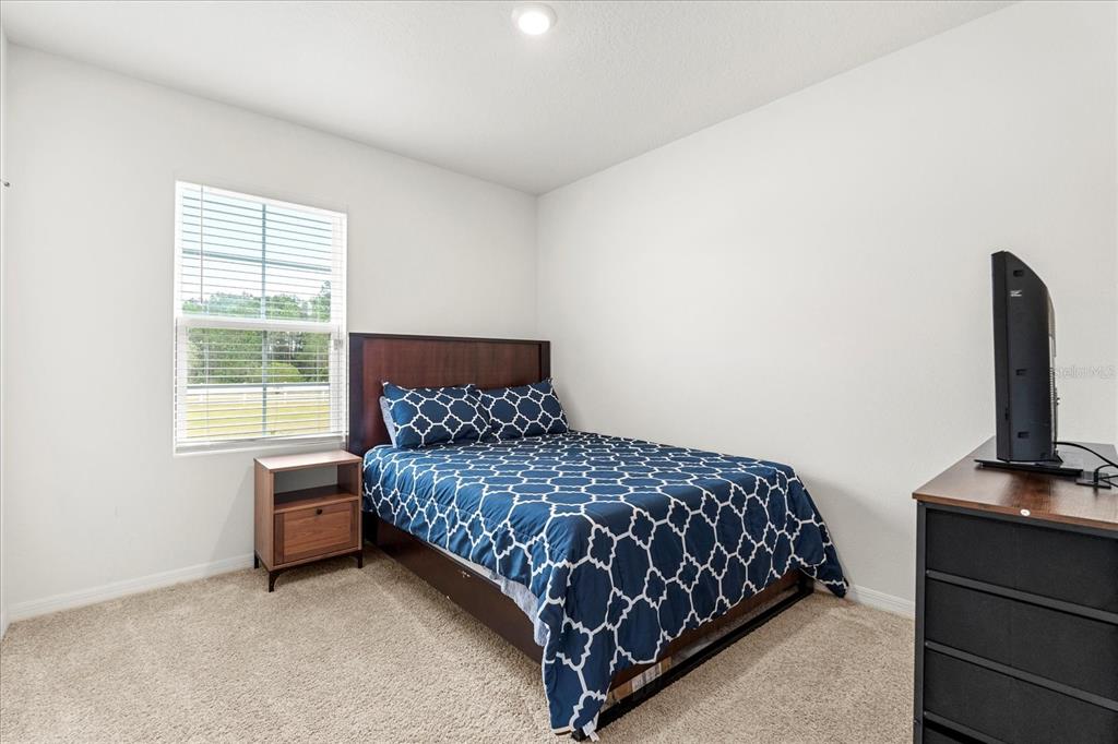 6895 Botanic Boulevard Harmony, FL 34773 - Photo 23 of 31 a bedroom with a bed and a window