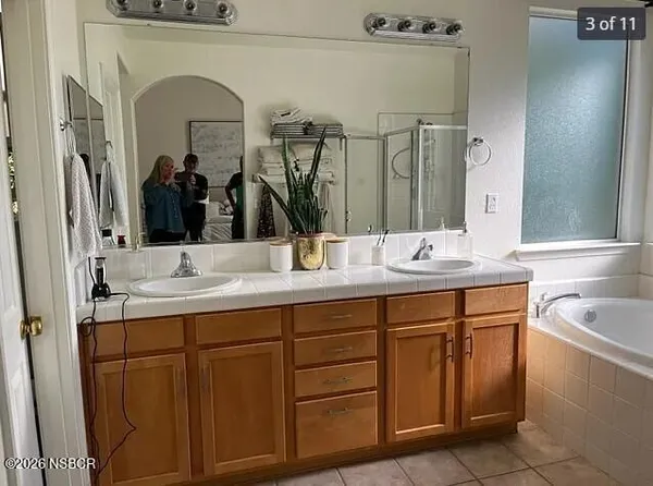 a bathroom with a granite countertop sink a mirror and vanity