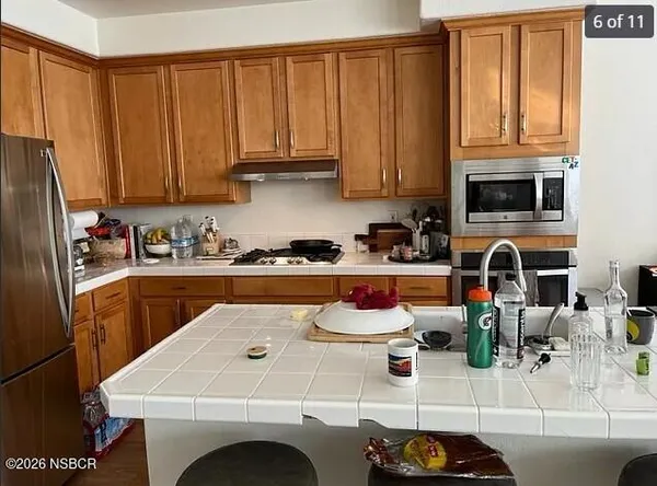 a kitchen with a sink a stove and cabinets