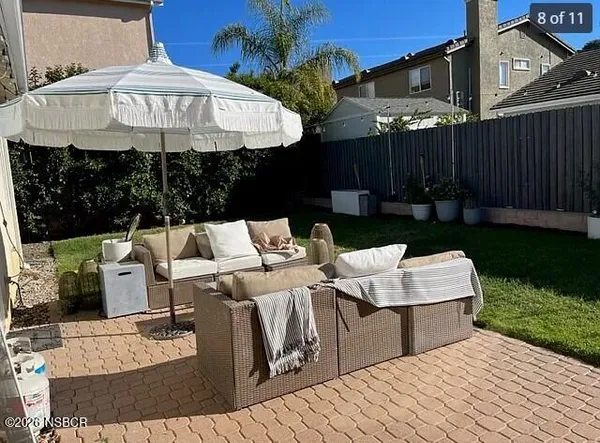 a front view of a house with yard and patio