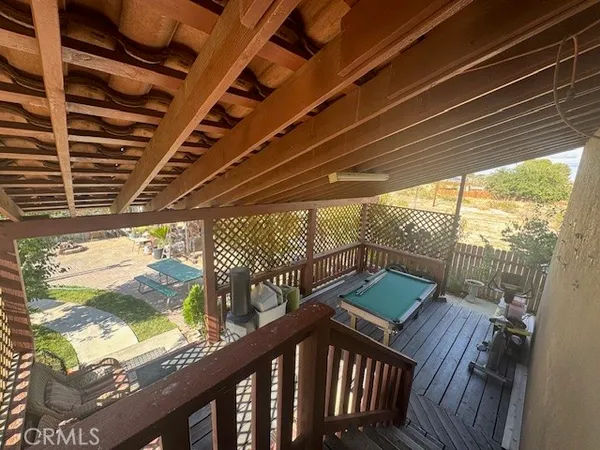 a view of a balcony with wooden floor and outdoor space