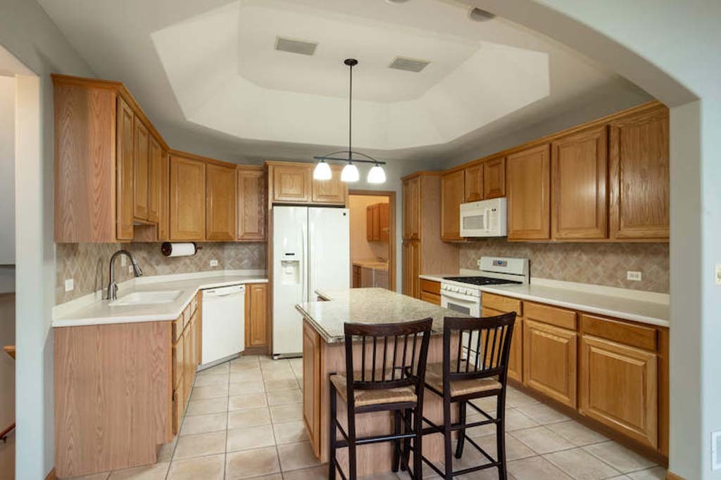 922 West Chesterfield Court Palatine, IL 60067 - Photo 2 of 19 a kitchen with a dining table chairs sink and cabinets