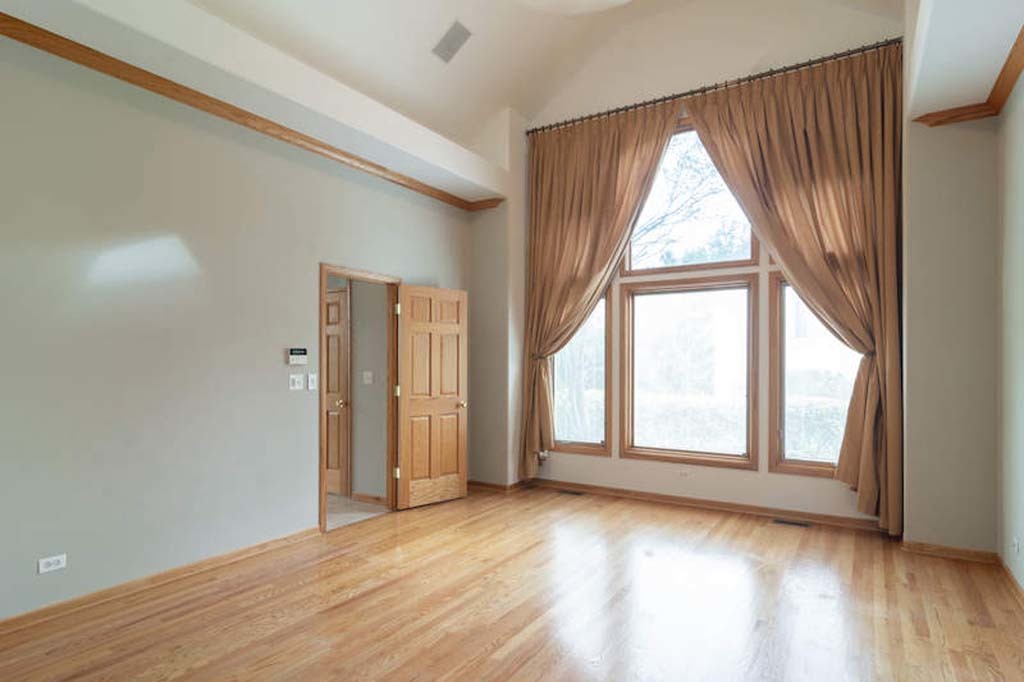922 West Chesterfield Court Palatine, IL 60067 - Photo 5 of 19 an empty room with wooden floor and windows