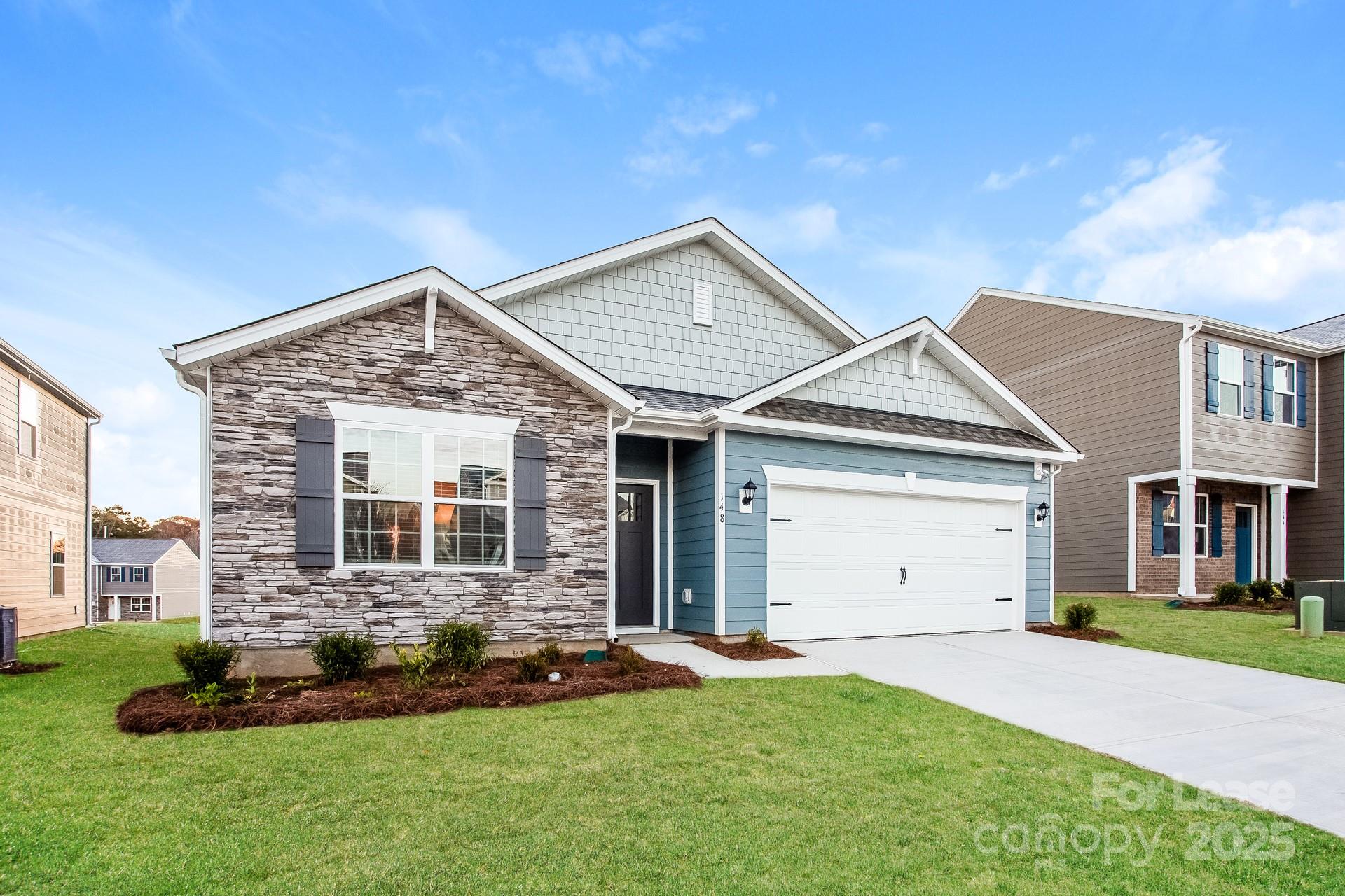 148 Way Cross Lane Troutman, NC 28166 - Photo 4 of 16 a front view of a house with a yard and garage