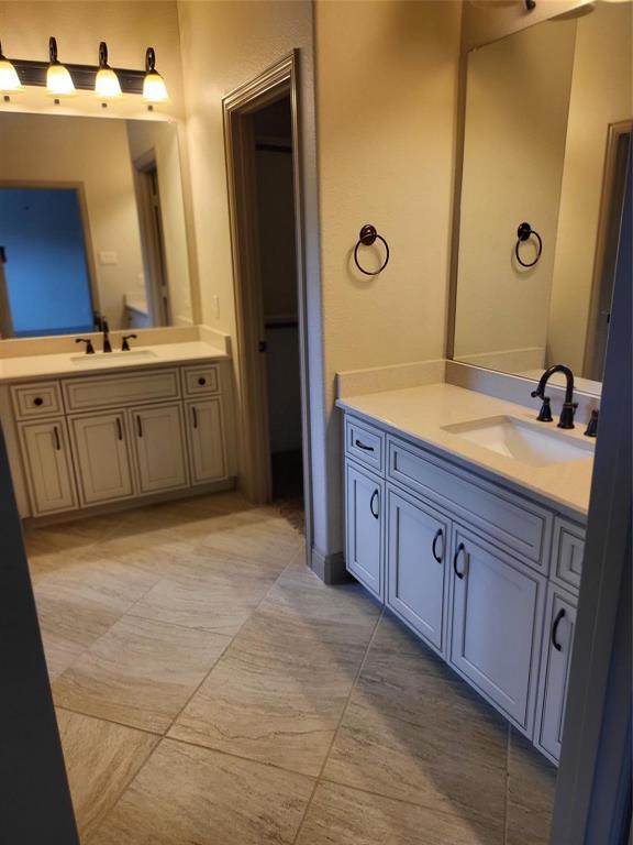 2229 Zenith Avenue Flower Mound, TX 75028 - Photo 13 of 18 a spacious bathroom with a double vanity sink and a mirror