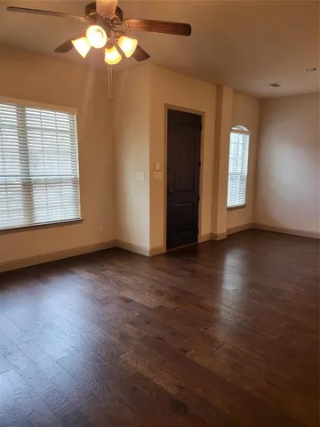 a view of wooden floor and windows in an empty room