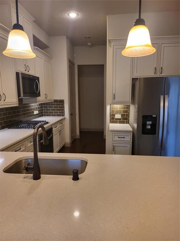 2229 Zenith Avenue Flower Mound, TX 75028 - Photo 5 of 18 a kitchen with a stove a sink and a refrigerator