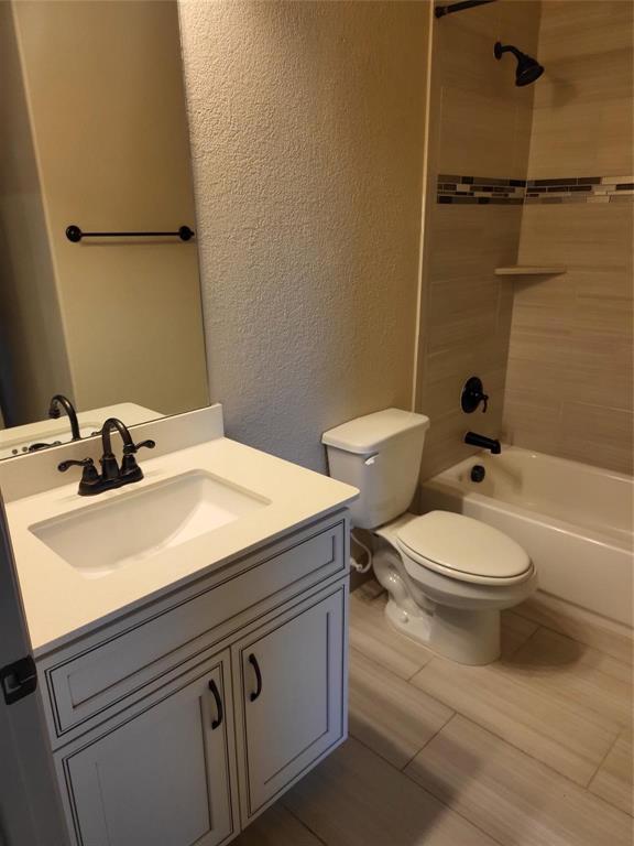 2229 Zenith Avenue Flower Mound, TX 75028 - Photo 9 of 18 a bathroom with a granite countertop toilet sink and mirror