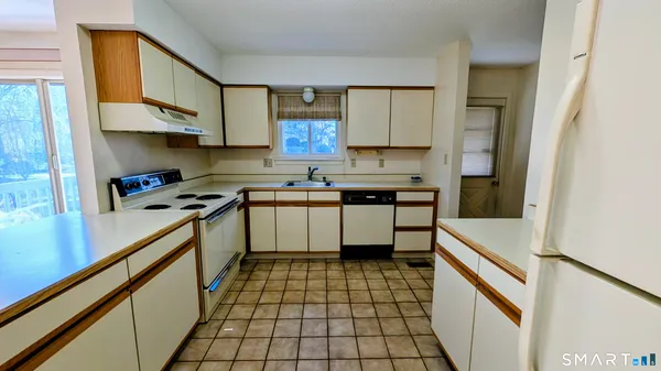 a kitchen with a sink a stove cabinets and counter space