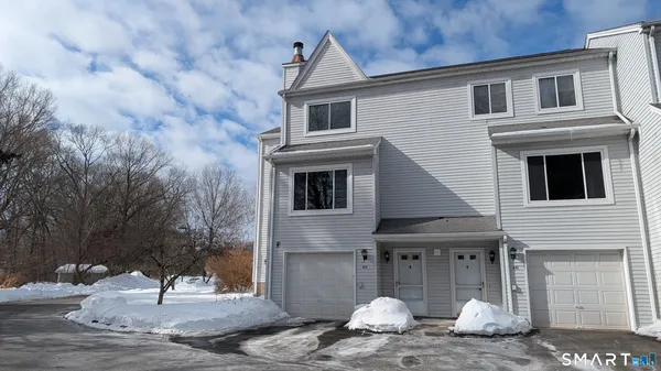 a house that has a tree in front of it