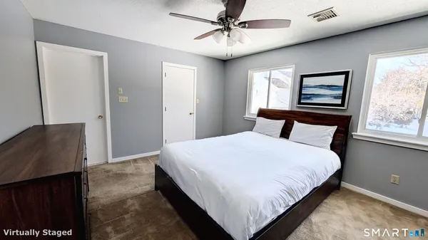 a bedroom with a bed and window