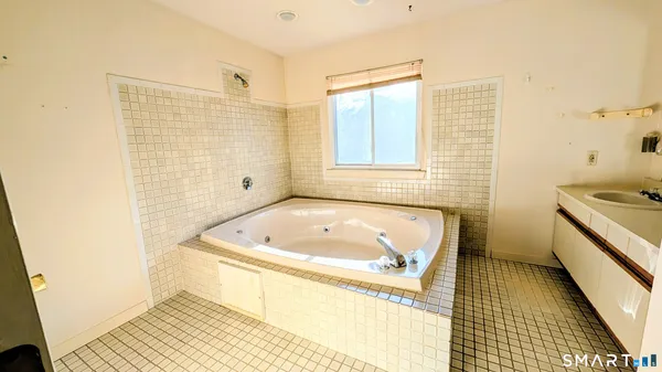 a bath room with a tub and a shower