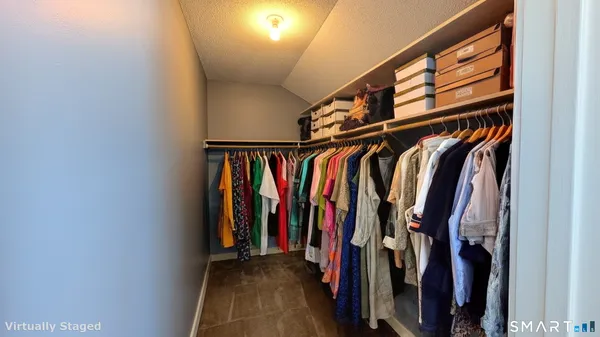 a view of walk in closet with clothes