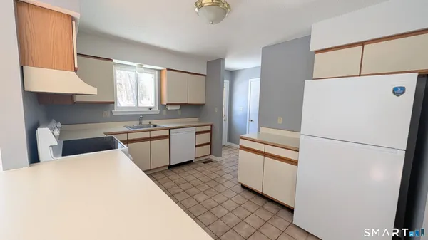 a kitchen with stainless steel appliances a refrigerator sink and cabinets
