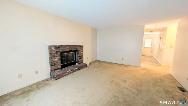 a view of empty room with a fireplace