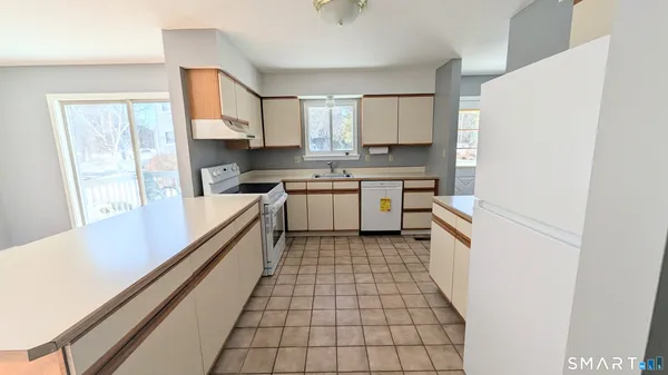 a kitchen with a sink a stove top oven and cabinets