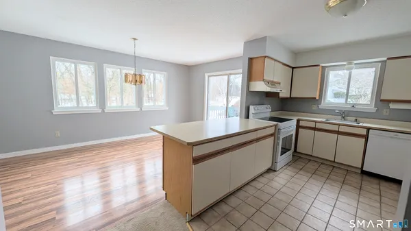 a kitchen with a stove sink and cabinets