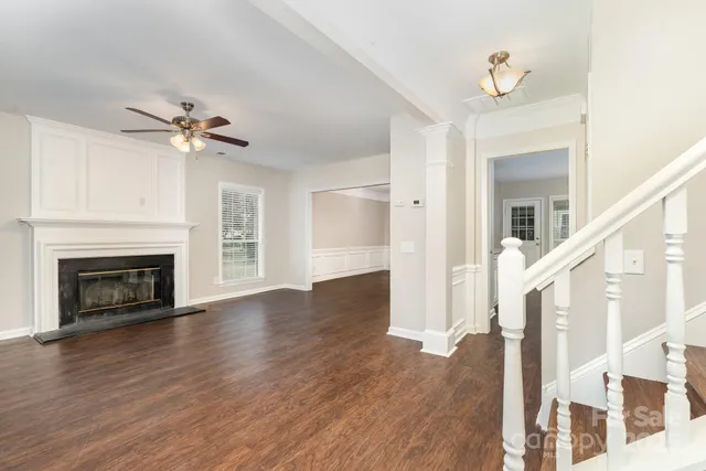 a view of a livingroom with a ceiling fan and a fireplace