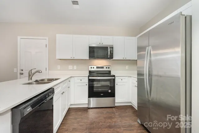 a kitchen with a refrigerator and a sink