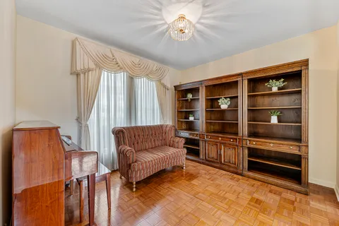 a living room with furniture a ceiling fan and a window