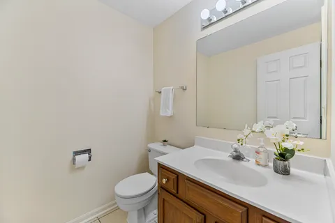 a bathroom with a sink toilet and a mirror